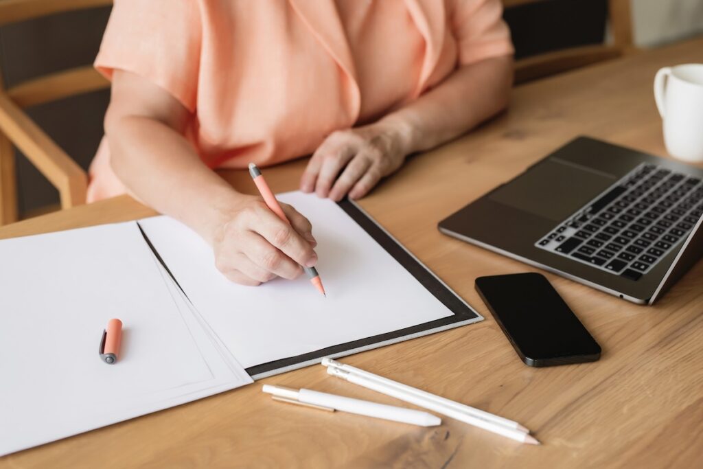 woman writing small business growth goals at her desk