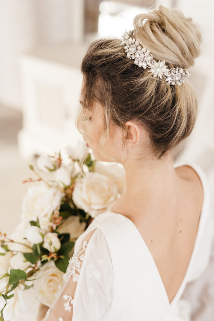 bride with updo bun hairstyle holding her bouquet