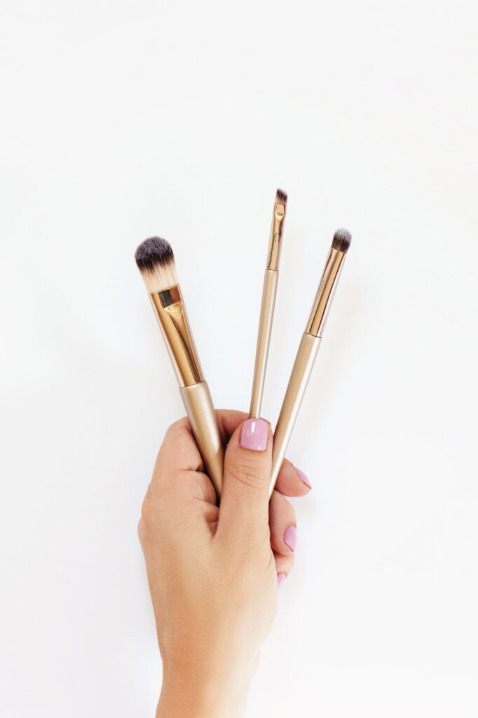 hand holding makeup brushes